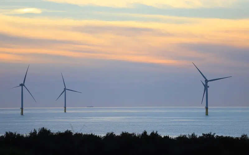 Offshore wind turbines at sunset